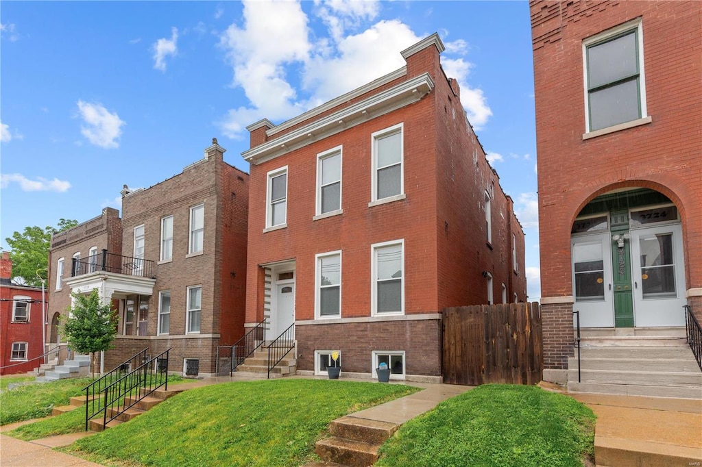 view of front of house with central AC unit and a front lawn