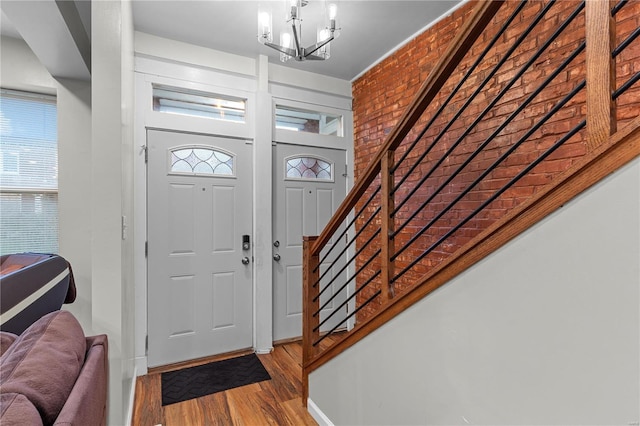 entrance foyer featuring plenty of natural light, a notable chandelier, and hardwood / wood-style flooring