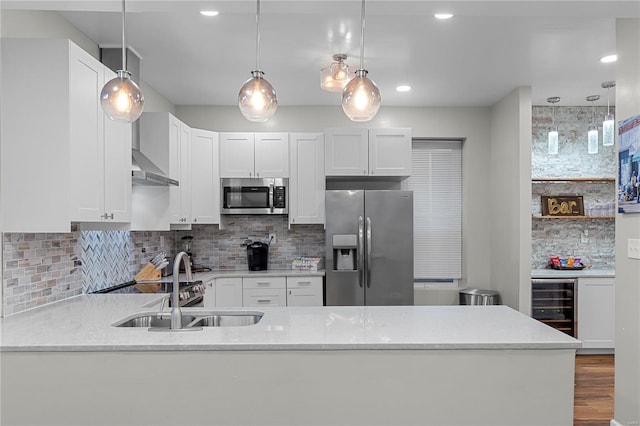 kitchen with decorative backsplash, stainless steel appliances, white cabinetry, and beverage cooler