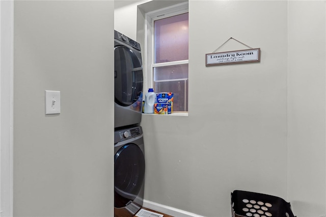 laundry area with stacked washer / dryer