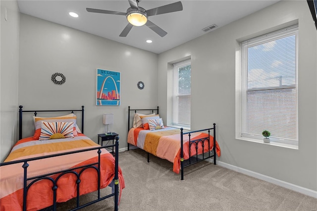 bedroom featuring ceiling fan and light carpet