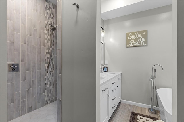 bathroom with vanity and a tub