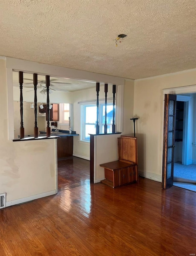 spare room with dark hardwood / wood-style floors and a textured ceiling