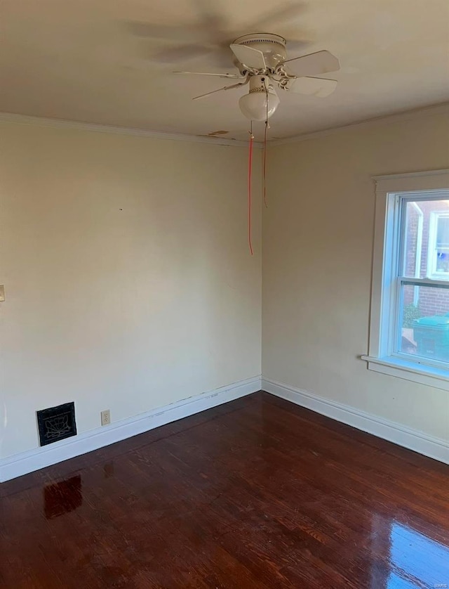 unfurnished room with crown molding, ceiling fan, and dark wood-type flooring