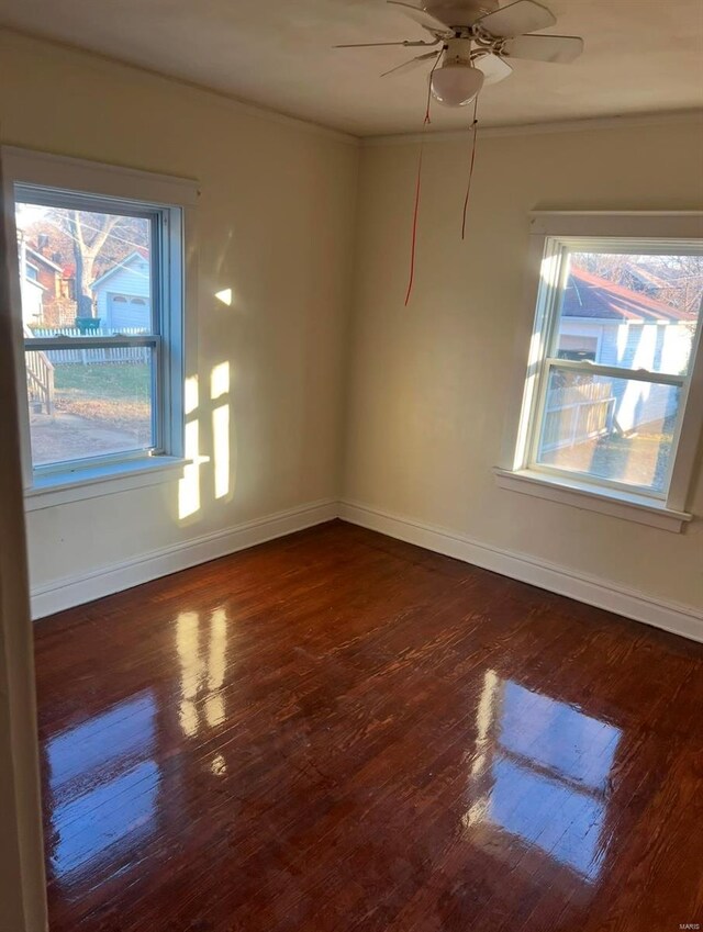 spare room featuring ceiling fan and dark wood-type flooring