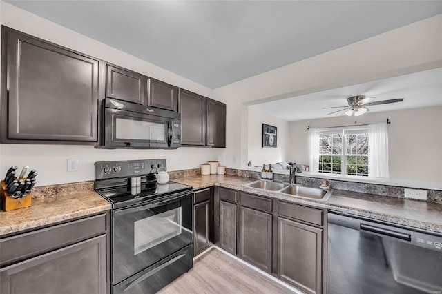 kitchen featuring black appliances, sink, ceiling fan, dark brown cabinets, and light hardwood / wood-style floors