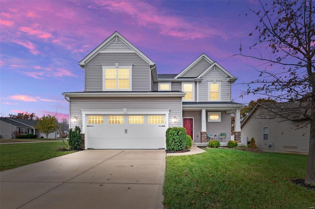 craftsman-style home featuring a yard and a garage