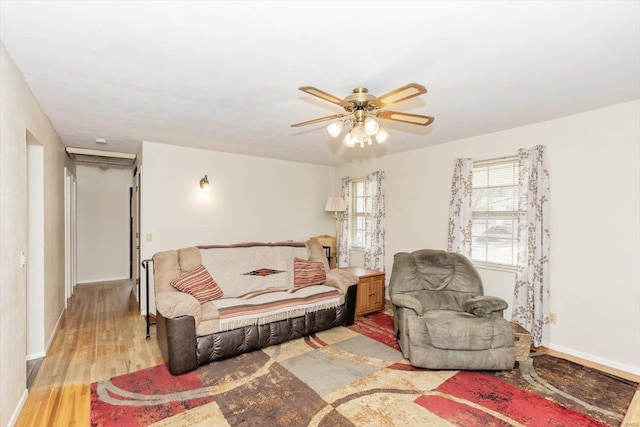 living room featuring light hardwood / wood-style flooring and ceiling fan