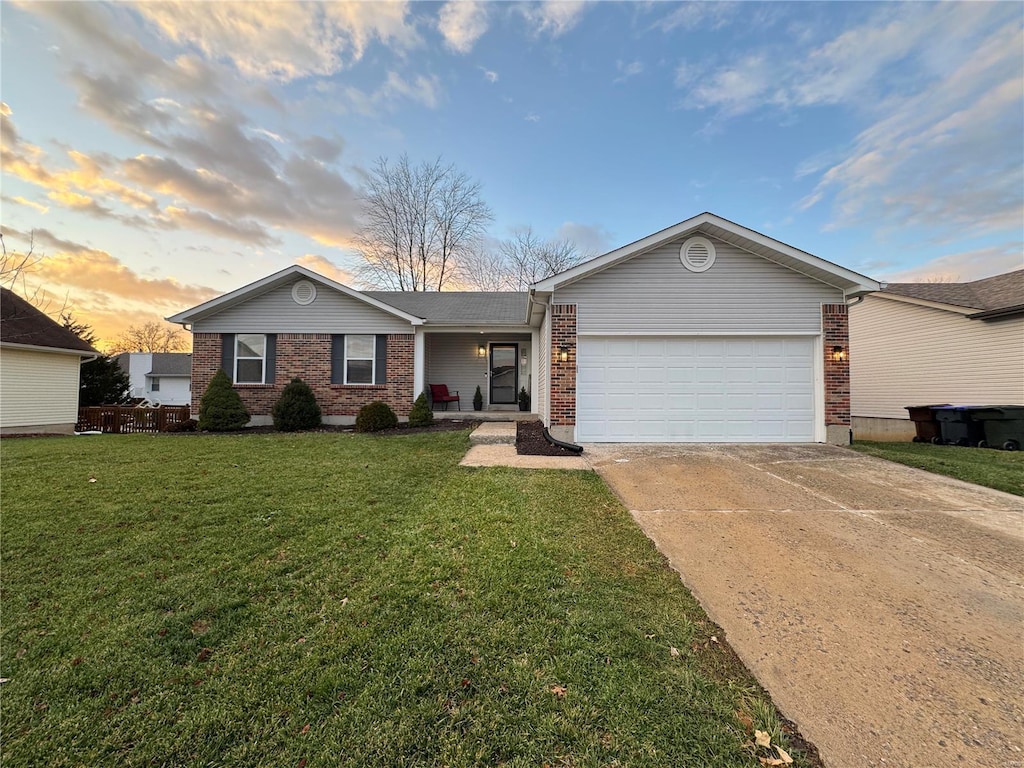 ranch-style house with a lawn and a garage