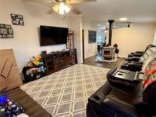 living room with wood-type flooring, a wood stove, and ornamental molding