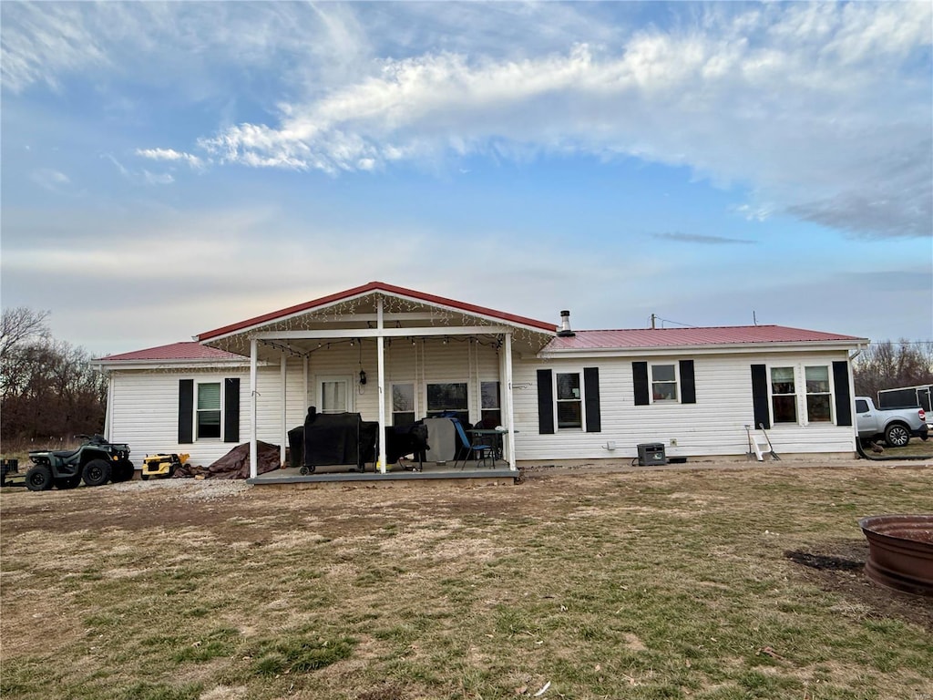 rear view of house with a yard