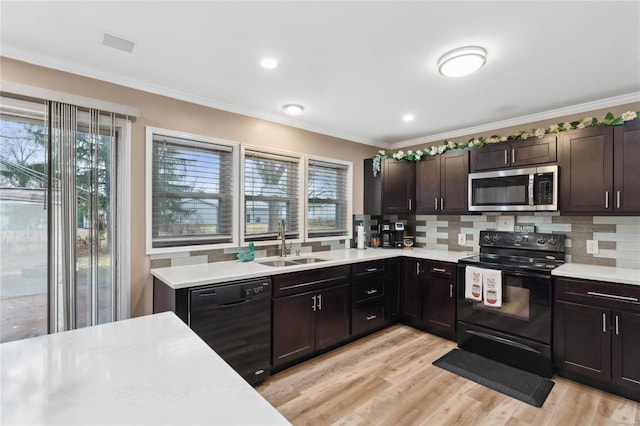 kitchen featuring light wood-type flooring, sink, dark brown cabinetry, and black appliances