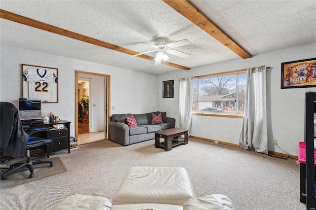 office with beam ceiling, ceiling fan, carpet floors, and a textured ceiling