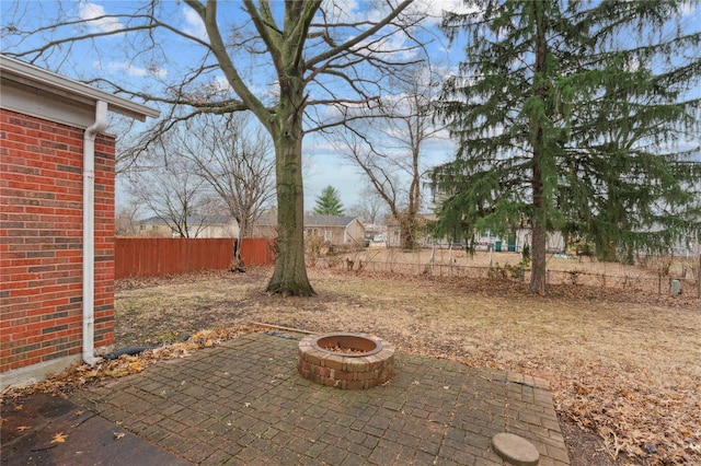 view of yard with a patio and an outdoor fire pit