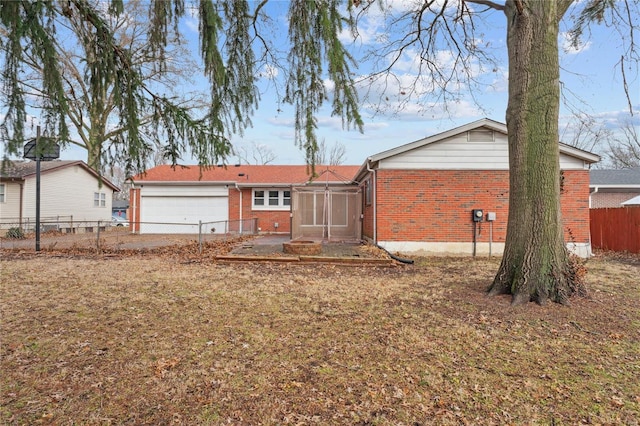 rear view of property featuring a garage