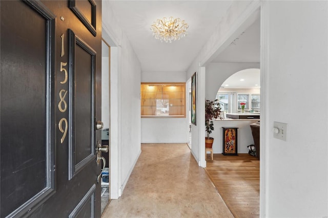 foyer featuring a notable chandelier and light hardwood / wood-style flooring