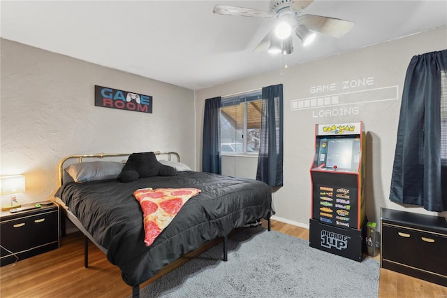 bedroom with hardwood / wood-style flooring and ceiling fan