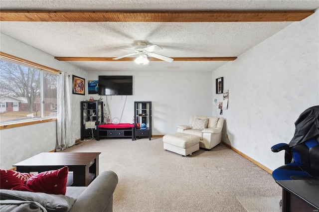 living room featuring carpet, ceiling fan, and a textured ceiling