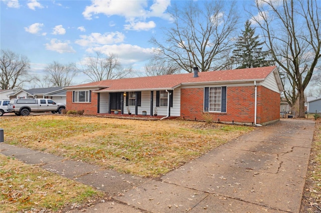 single story home featuring covered porch and a front yard