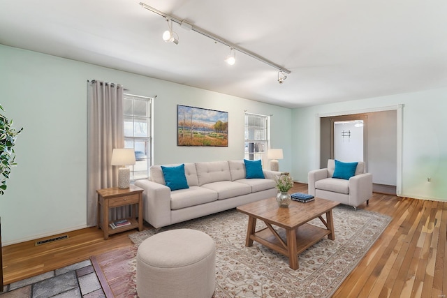 living room featuring plenty of natural light and light hardwood / wood-style flooring