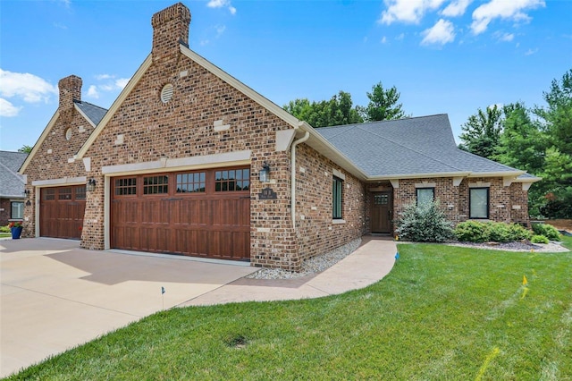 view of front of home with a garage and a front lawn