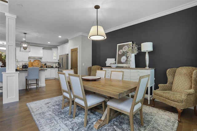 dining area with ornamental molding and dark wood-type flooring