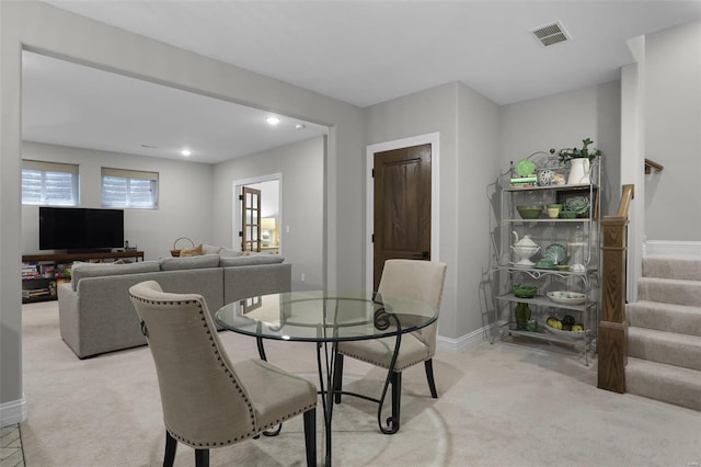 dining area featuring light carpet