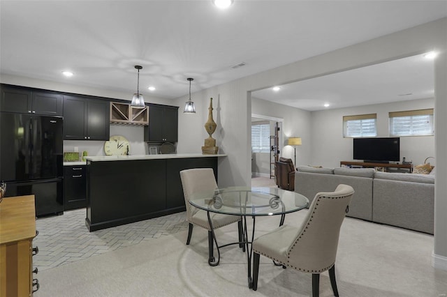 carpeted dining space with a healthy amount of sunlight