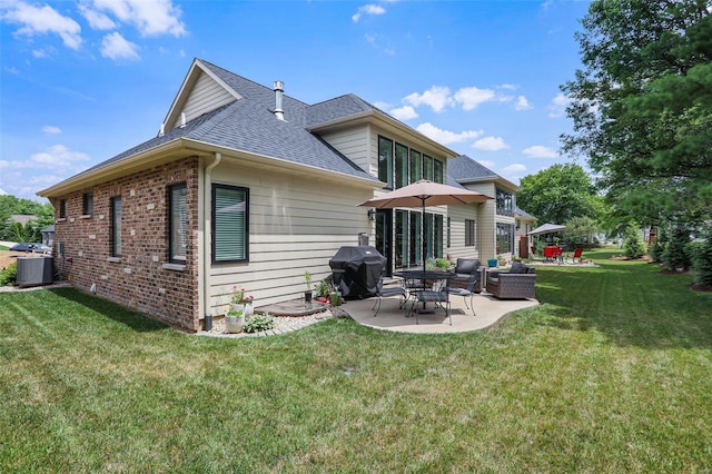 rear view of property featuring a lawn, a patio area, and central AC unit