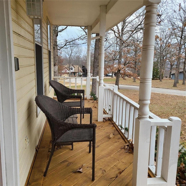 wooden terrace featuring covered porch