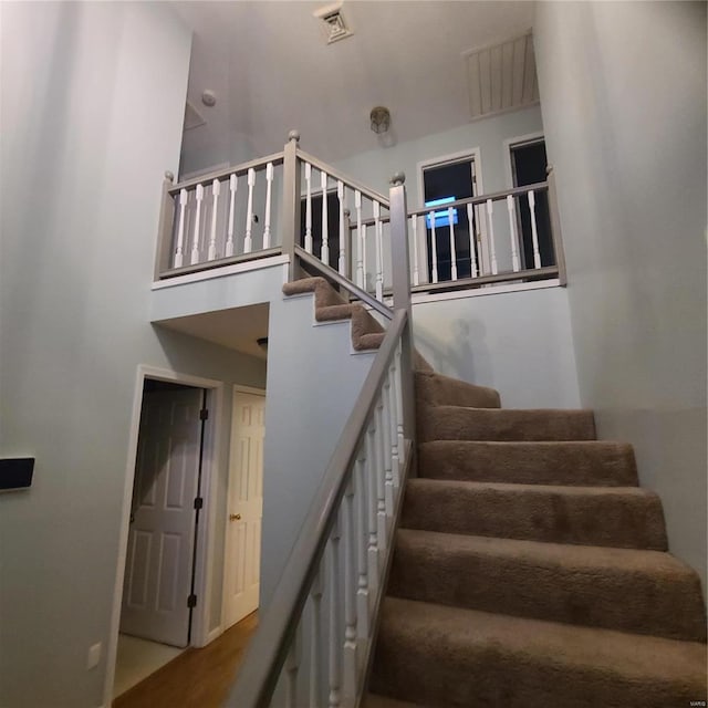 stairs with hardwood / wood-style flooring