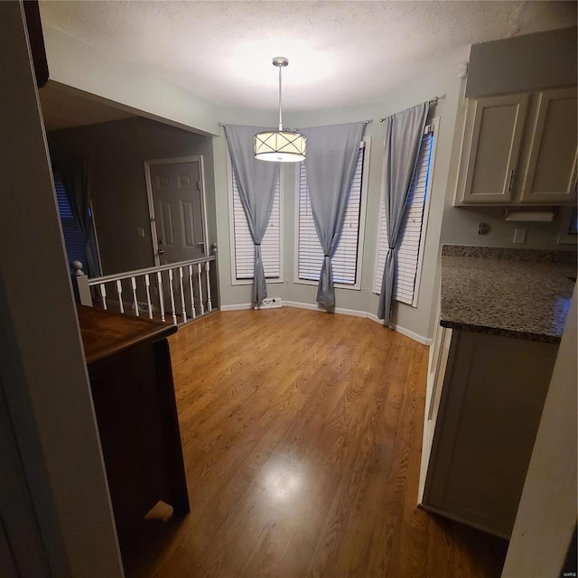 dining area featuring hardwood / wood-style floors and a textured ceiling