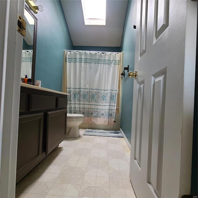 full bathroom featuring vanity, toilet, lofted ceiling with skylight, and shower / tub combo with curtain