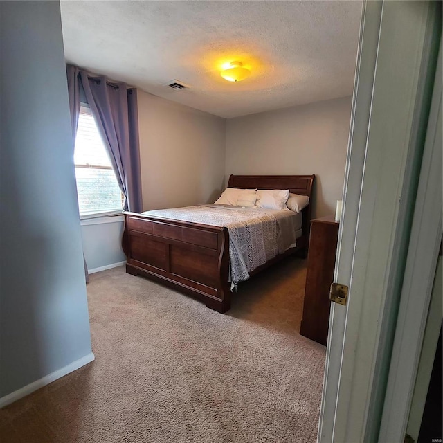 carpeted bedroom with a textured ceiling