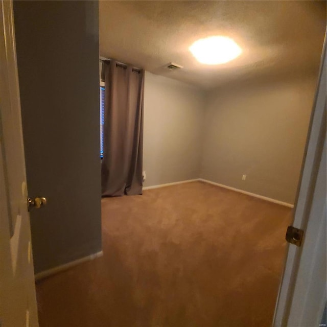 unfurnished room featuring carpet