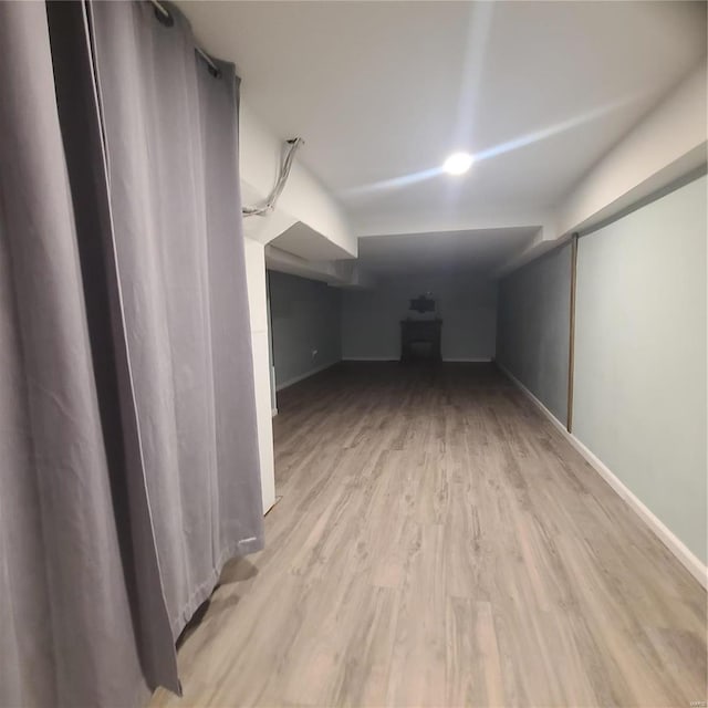 additional living space with light hardwood / wood-style floors