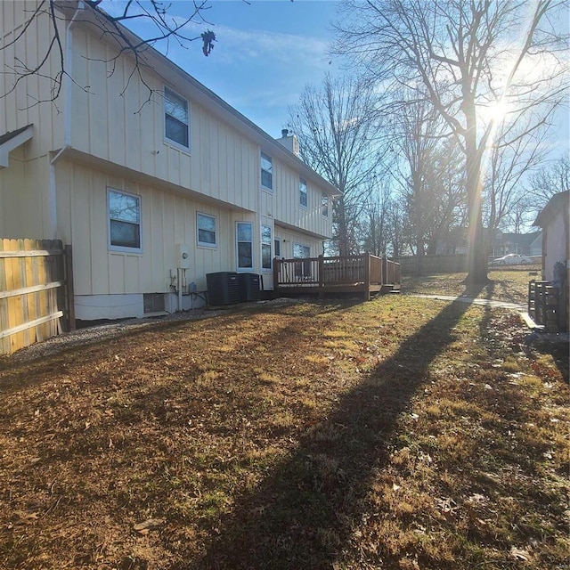 rear view of property featuring central AC and a deck