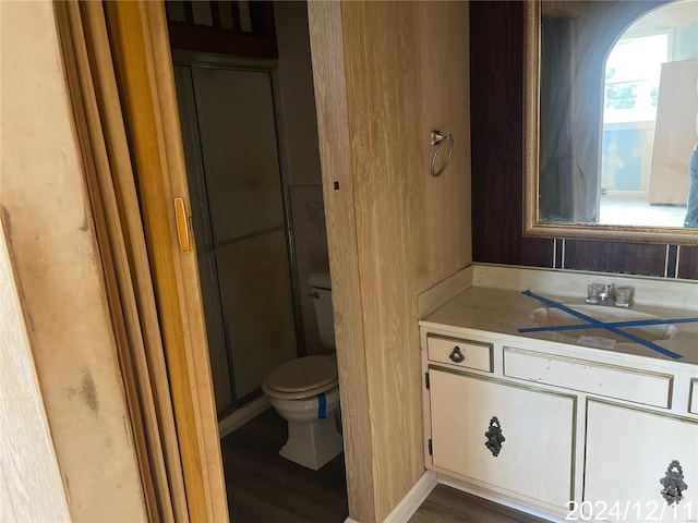 bathroom featuring hardwood / wood-style flooring, vanity, and toilet