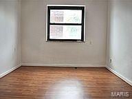 spare room with hardwood / wood-style floors