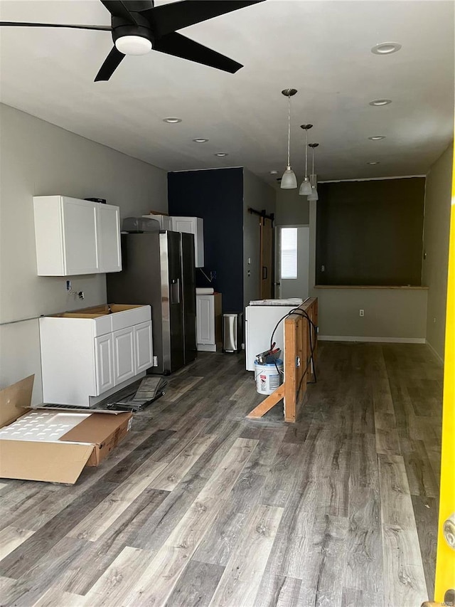 kitchen with stainless steel refrigerator with ice dispenser, ceiling fan, wood-type flooring, decorative light fixtures, and white cabinetry