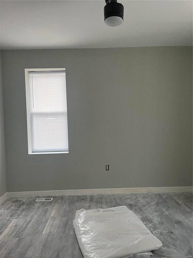 empty room with hardwood / wood-style flooring