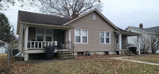 view of front of property with central AC and a front yard