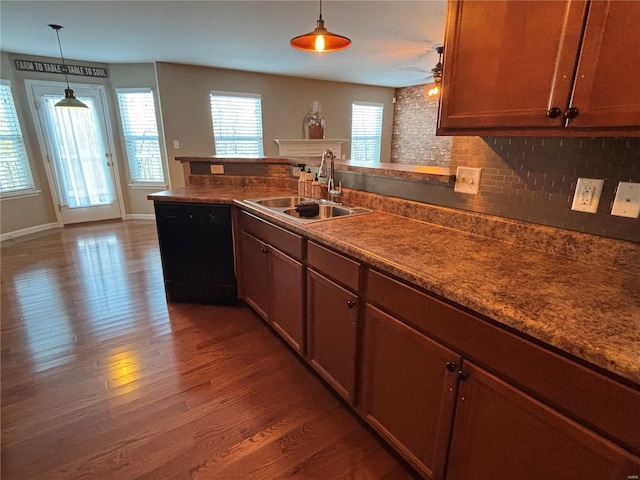 kitchen featuring sink, hanging light fixtures, dark hardwood / wood-style flooring, black dishwasher, and backsplash