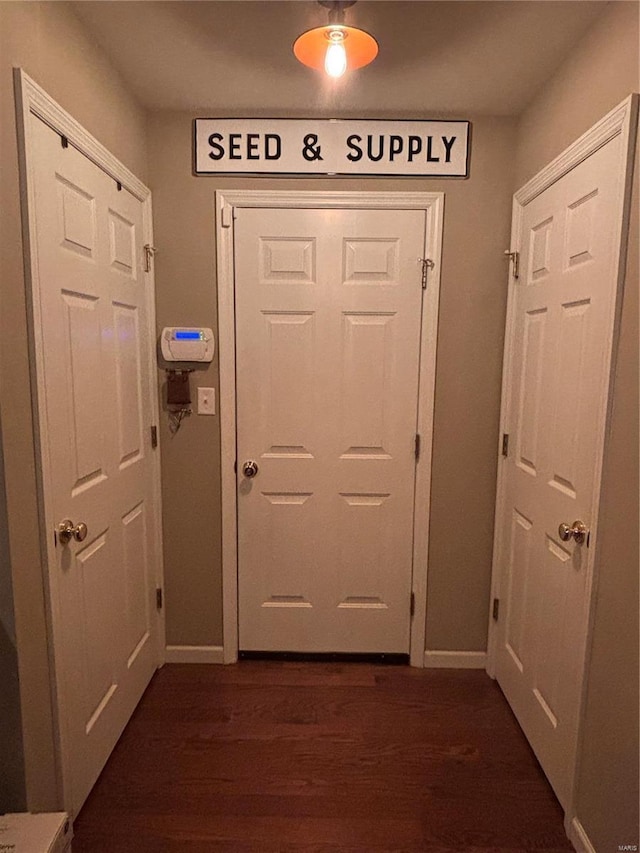 entryway with dark hardwood / wood-style flooring