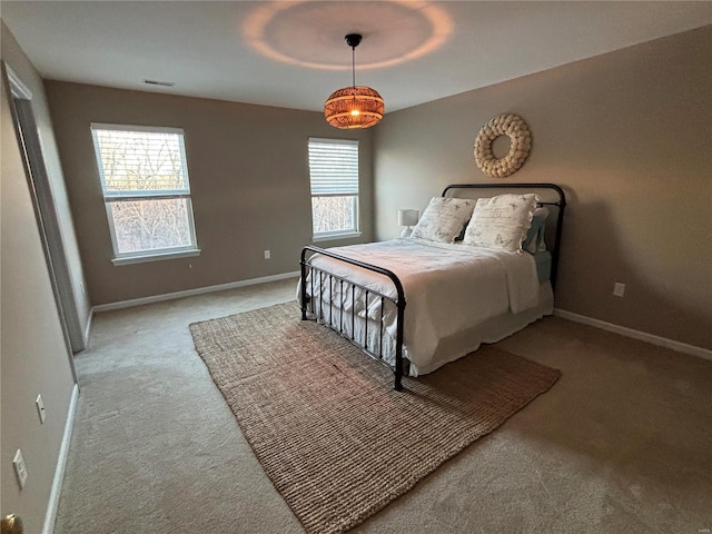 bedroom featuring multiple windows and light colored carpet