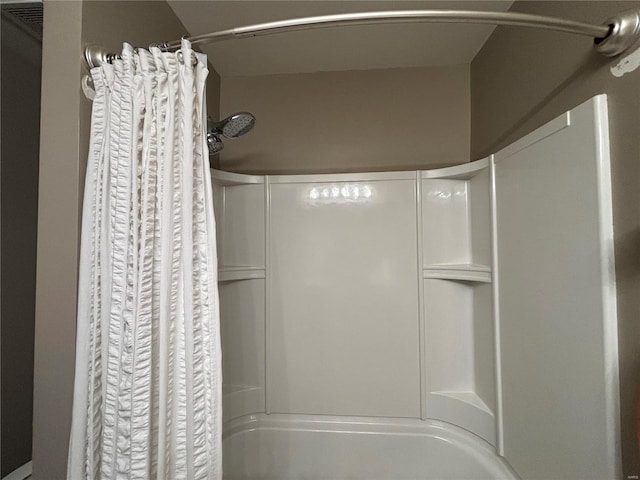 bathroom with shower / bath combo with shower curtain