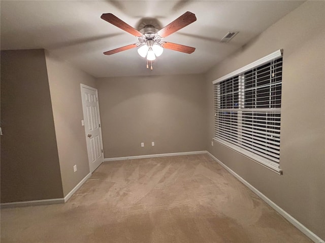 carpeted spare room with ceiling fan