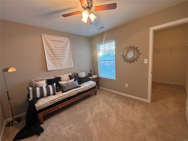 sitting room with ceiling fan and carpet floors