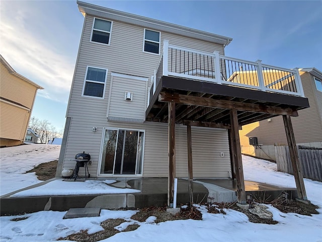 snow covered house featuring a balcony