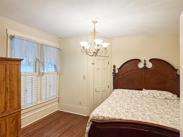 bedroom featuring dark hardwood / wood-style floors and an inviting chandelier